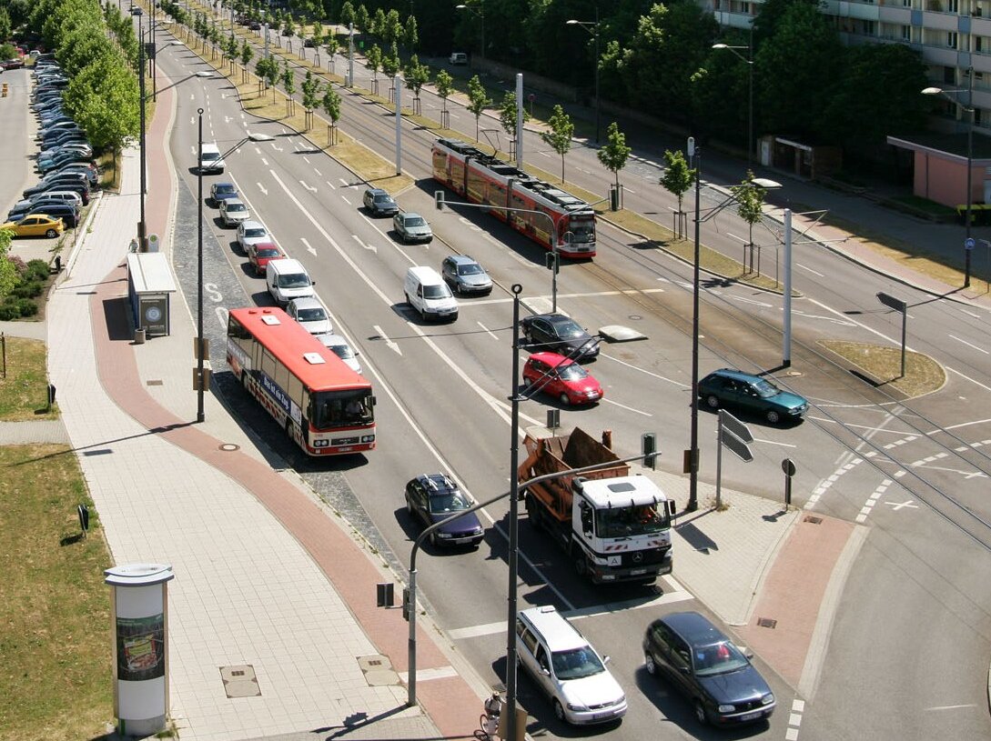 Bild einer Straße mit Autos, Bus, Straßenbahn und Lastkraftwagen