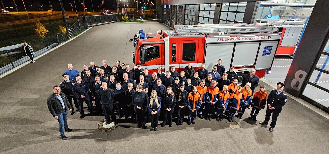 Menschen vor dem Fahrzeug an der Feuerwache